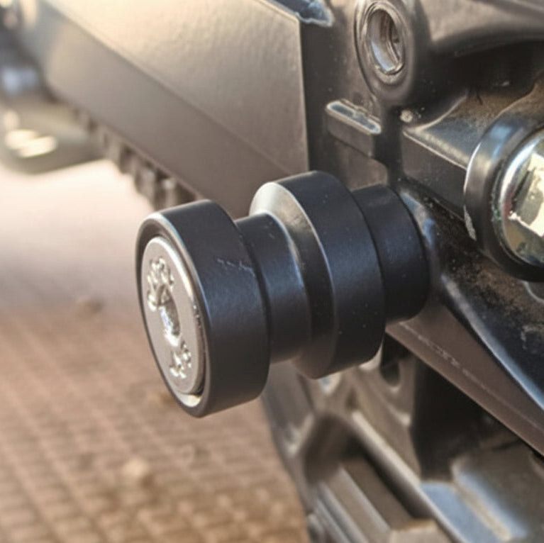 Close-up of a mechanical component on a vehicle, possibly a chain or gear system. (KTM Adventure 390 (Old) Swingarm Spools)